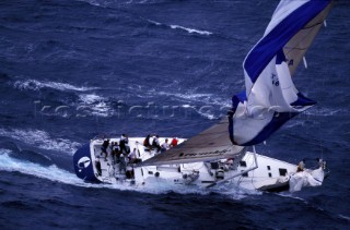Maxi yacht Edimetra with collapsed spinnaker in rough seas