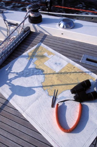Navigational equipment including binoculars dividers and nautical chart 