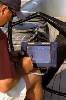 Maxi yacht - Rolex Cup - man using RaceVision unit. ©Kos/Strategic/KPS 5.6859. Crew member using navigation computer