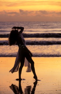 Model Jilly Johnson alone on a sandy beach in the sunset in Australia