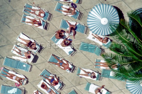 Aerial view of sunbathers by a hotel pool