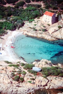 Aerial view of secluded cove and house on rocks