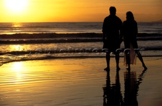 Romantic couple on a beach at sunset in Australia