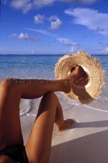Girl model on beach with straw hat