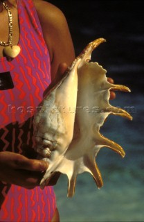 Caribbean girl holding Conch shell