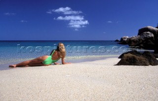 Model girl on idyllic beach on Lizard Island Great Barrier Reef Queensland Australia