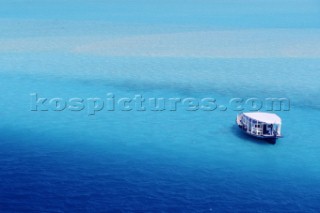 Boat anchored in blue sea, Maldives.