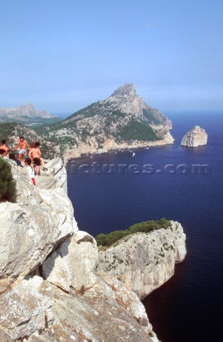 People take in a stunning view from a Mediterranean cliff top