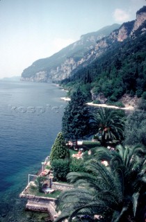 People relax on a garden terrace on the shore of lake Garda