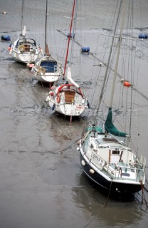 Four sailing yachts upright on the mud at low tide, Newtown Creek, Isle of Wight