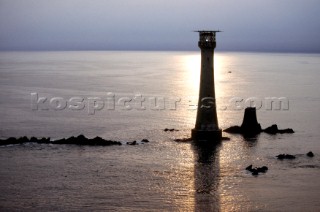 Sun reflections on the sea at Eddystone lighthouse off the coast of Plymouth, Devon, UK