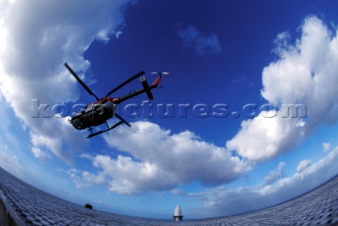 Helicopter flying over Eddystone lighthouse near Plymouth UK