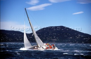 Sailing yacht with reefed mainsail sailing in rough water