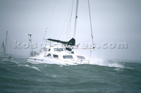 Multihull sailing yacht in rough seas