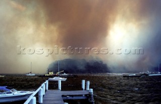 Smoke from a forest fire engulfs an island in Australia