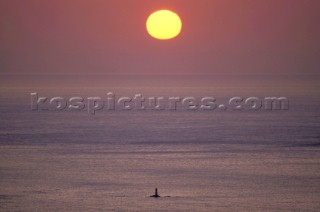 Sunset over lighthouse in the Mediterranean