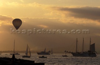 Hot air balloon flying over the harbour of Saint Tropez, France at sunset