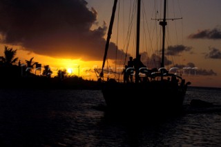 Silhouette of cruising yacht at sunset in St Lucia, Caribbean