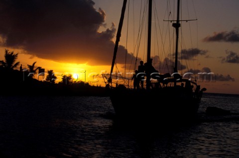 Silhouette of cruising yacht at sunset in St Lucia Caribbean