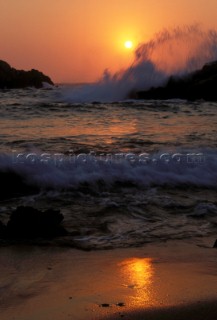Sea breaking on rocks at sunset, Island of Kos, Greece