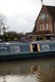 Canal boat moored outside public house (pub).  Canal boats on English Kennet and Avon Canals.