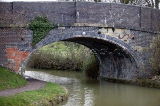 Road bridge over Kennet and Avon canal and river.  Canal boats on English Kennet and Avon Canals.