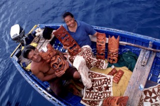 Locals come along side charter and pleasure boats selling their hand crafted art in Tonga.