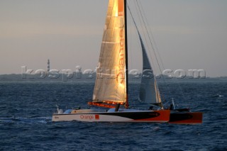Maxi catamaran Orange skippered by Bruno Peyron crossing the startline of the Jules Verne