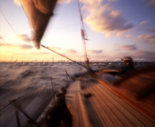 Classic yacht cruising in the sunset aboard Tenacity