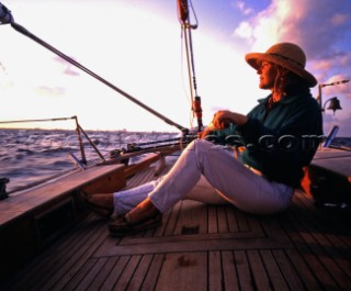 Girl steering classic yacht