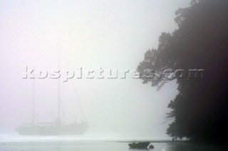 Yachts in the fog and mist on the River Dart in Devon