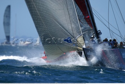 Switerlands Alinghi Challenge perpares to round the top mark head of Team New Zealand which lowered 