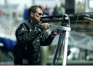 Team New Zealand designer Clay Oliver secures the broken boom onboard NZL-82 as they return to the Viaduct Basin during day one of the Americas Cup, Auckland, New Zealand. Feb, 15. 2002. Team New Zealand retired from todays match after breaking a boom and damaging their head foil making the score 1-0 to Alinghi. (Mandatory credit: Sergio Dionisio/Oceanfashion Pictures)