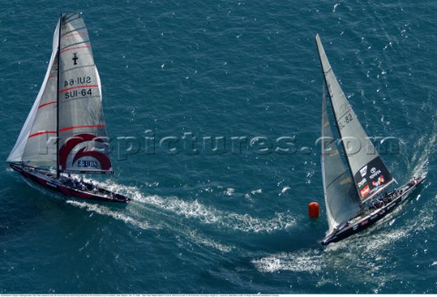 Switzerlands Alinghi Challenge leads Team New Zealands NZL82 around the top mark during race two of 
