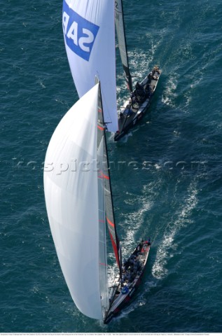 Switzerlands Alinghi Challenge leads Team New Zealands NZL82 on the down wind leg to the bottom mark