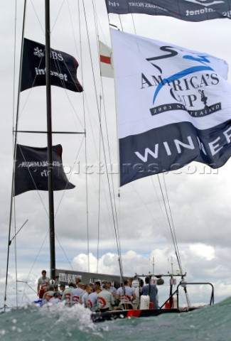Switzerlands Alinghi Challenge carry the winner flag after defeating Team New Zealands NZL82 during 