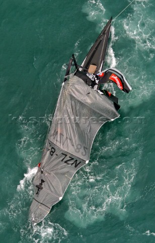 Team New Zealands NZL82 stops dead in the water after breaking their mast during race four the Ameri