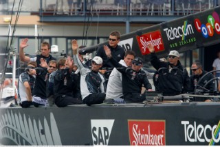 Crew members onboard Team New Zealands NZL-82 wave at fans before race four of the Americas Cup in Auckland, New Zealand. Feb, 25. 2002. Alinghi Swiss Challenge lead Team New Zealand 3-0 in the best of nine races.