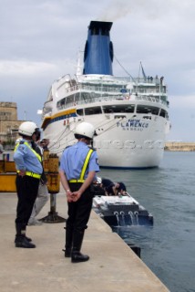 28/5/04.Valletta, Malta:The Malta police look on in interest at the teams preparing their boats in Valletta harbour