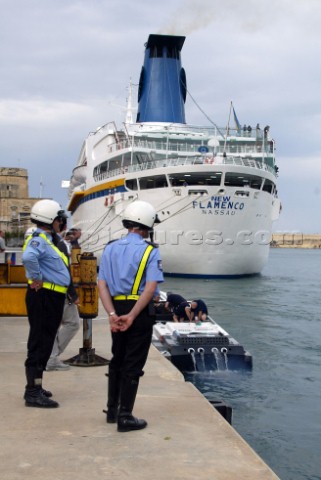 28504Valletta MaltaThe Malta police look on in interest at the teams preparing their boats in Vallet