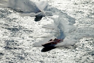 Offshore powerboats in silhouette at a turning mark