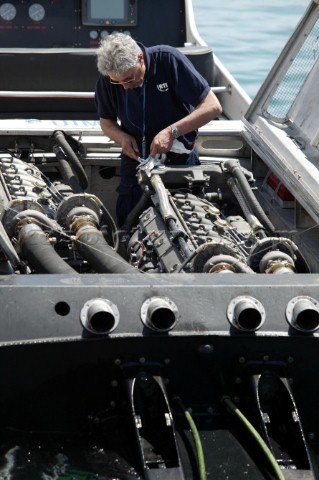 Enginerrs works on an engine in an offshore Powerboat P1