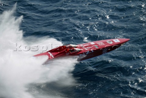 A powerboat crashes through a wave