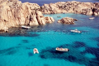 Boats moored in clear water on the Costa Smerelda, Sardinia, Italy