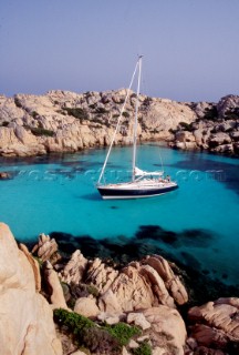 Cruising yacht in secluded anchorage, Sardinia, Italy.