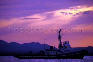 Tug boat in the port of Cagliari, Sardinia, during a dramatic sunset