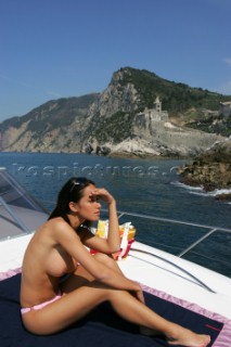 A glamorous model onboard a luxurious powerboat in the Mediterranean