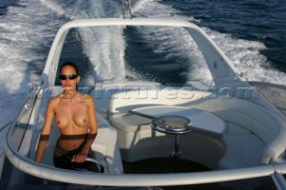 Topless woman on a boat