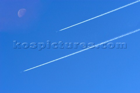 Two Jet planes in the sky with moon Digital image moon and extra plane added