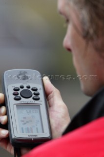 Man using Garmin handheld GPS navigation equipment